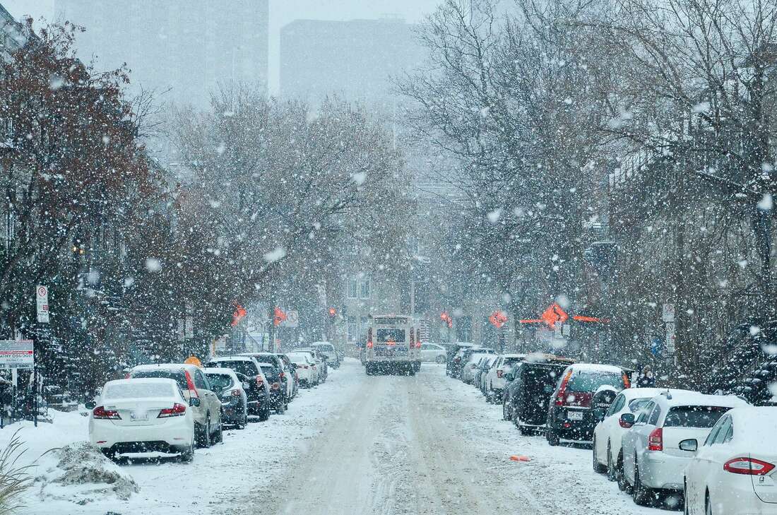 Snow in the city, vehicles around town in the winter.